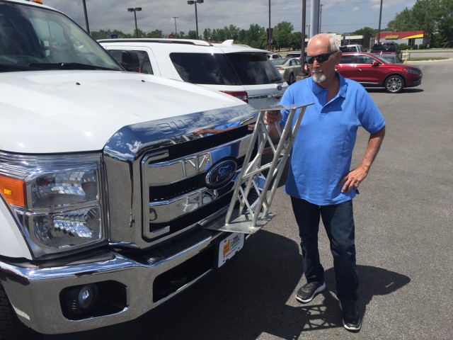 Mike Cullom checks the laser tower on the new 2016 L-KOPIA F-350 Laser Truck outside Art Hill Ford in Merrillville, IN. The truck is now at Pyramid, Rolling Prairie, Indiana, for hy-rail and laser system installations.